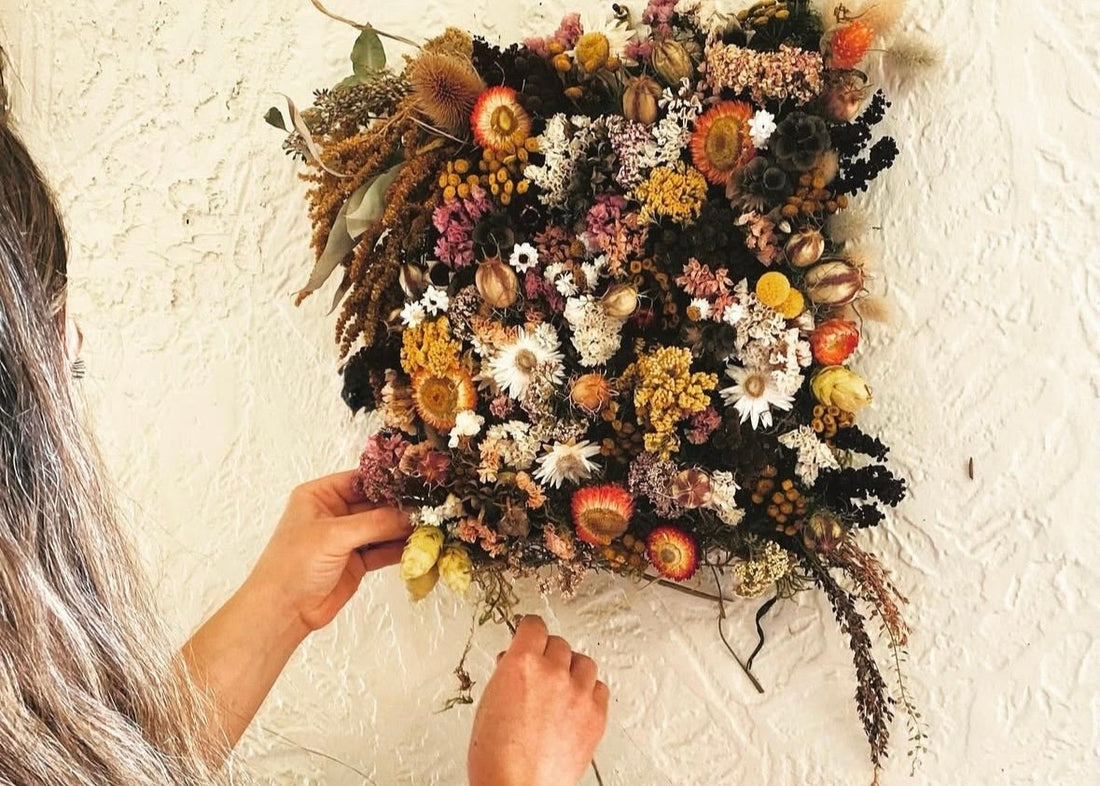 Farmer florist Alyssa O'Cotter arranging dried botanical flowers at Sweet Alyssum Farm on Vashon Island