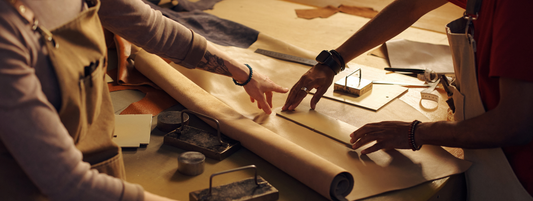 two people working with paper making prints