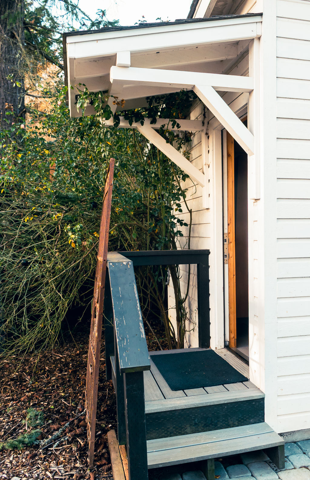 Wooden porch with greenery in the background