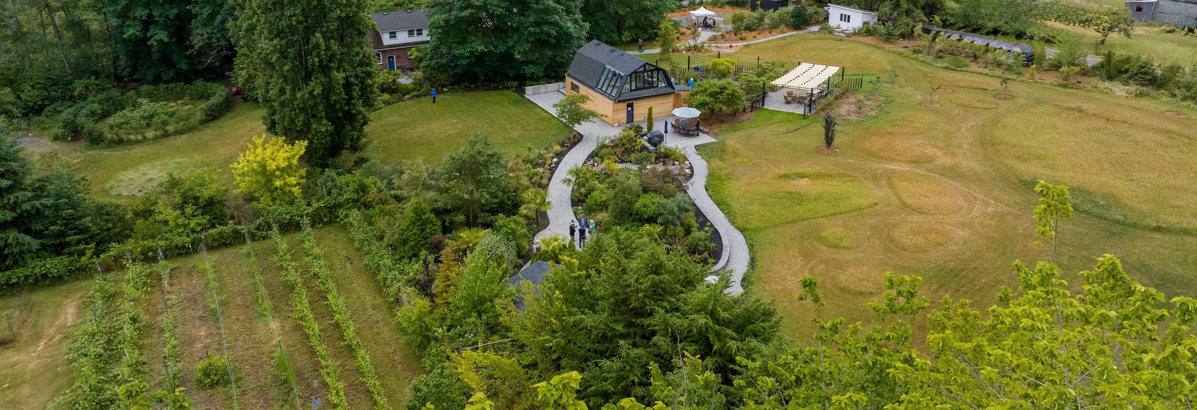 Aerial view of a garden with a small house and pathways